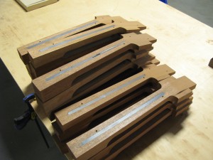 Stacks of would-be necks, truss rods exposed